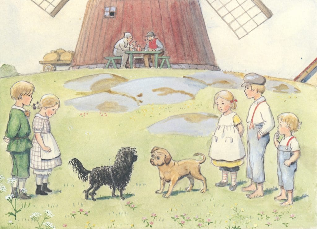 Kids Surrounding Dogs In Front Of A Windmill